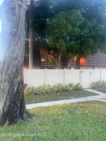 a backyard of a house with lots of green space and lake view