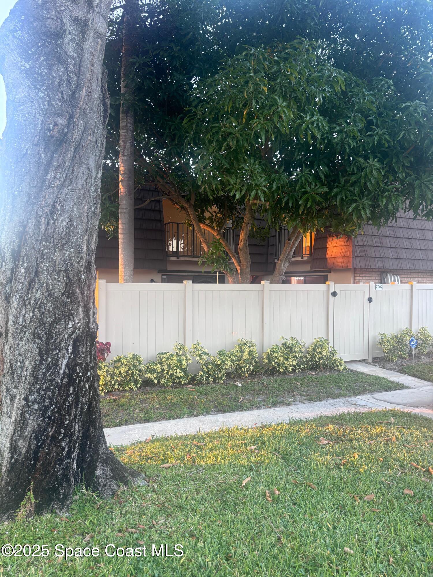 a backyard of a house with lots of green space and lake view