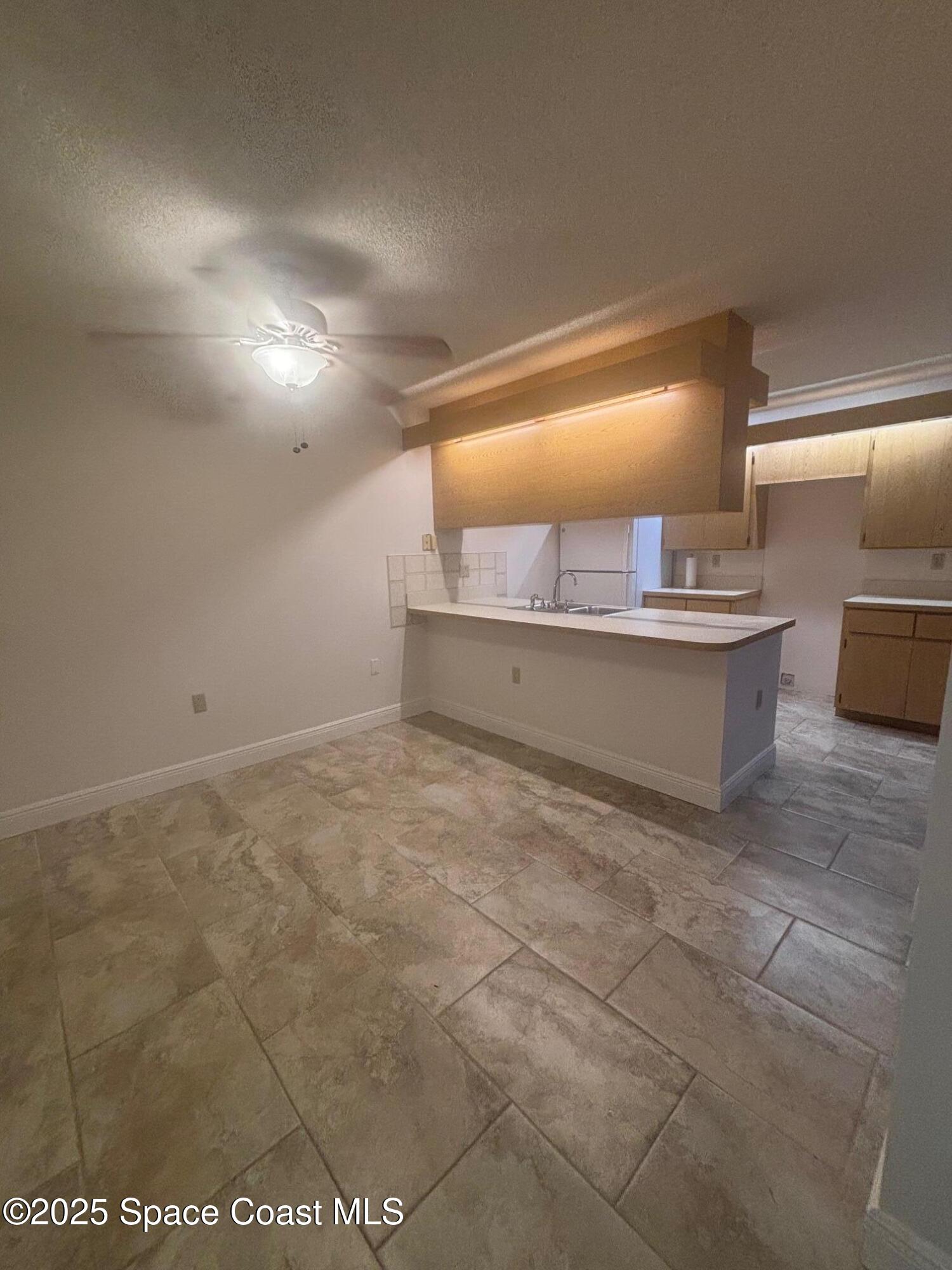 7002 70th Way, Unit 7002 West Palm Beach, FL 33407 - Photo 11 of 39 a view of kitchen and hall