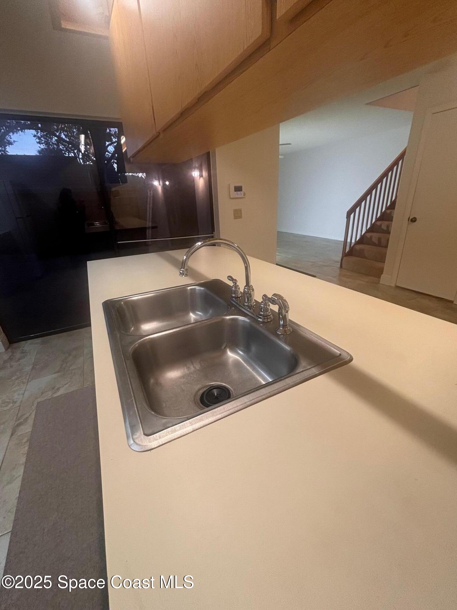 7002 70th Way, Unit 7002 West Palm Beach, FL 33407 - Photo 14 of 39 a kitchen with a sink and mirror