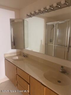 7002 70th Way, Unit 7002 West Palm Beach, FL 33407 - Photo 23 of 39 a bathroom with a sink and a mirror