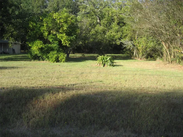 a view of empty space with swimming pool and trees