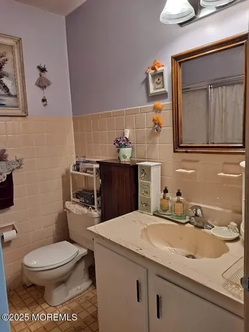 a bathroom with a toilet sink and mirror