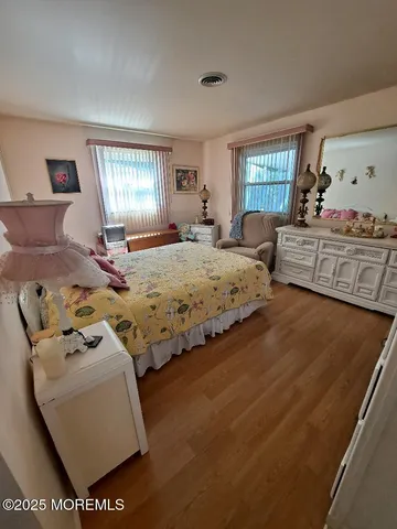 a bedroom with two beds and a large window