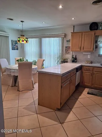 a kitchen with a sink a counter top space and cabinets
