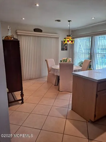 a dining room with furniture and a window