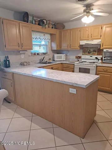 a kitchen with stainless steel appliances granite countertop a sink counter space cabinets and a large window