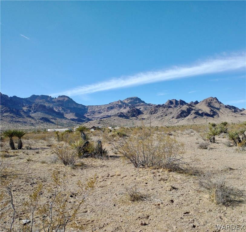 3448 South Mockingbird Road Golden Valley, AZ 86413 - Photo 7 of 16 a view of a lake with mountains in the background