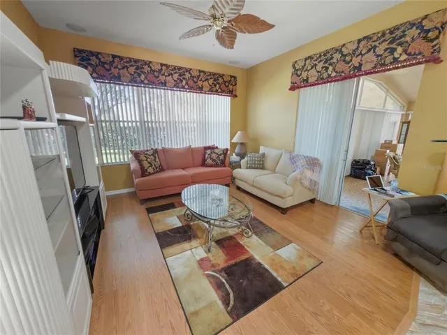 a spacious bedroom with a bed and a chandelier