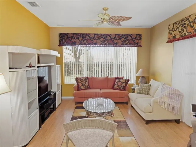 a spacious bedroom with a large bed and chandelier