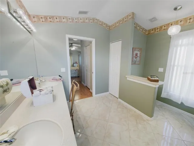 a bathroom with a sink vanity granite and toilet
