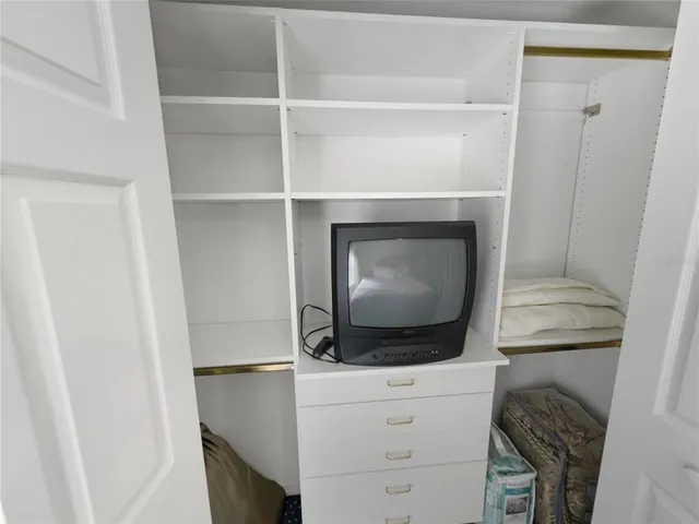 a living room with furniture a flat screen tv and a table