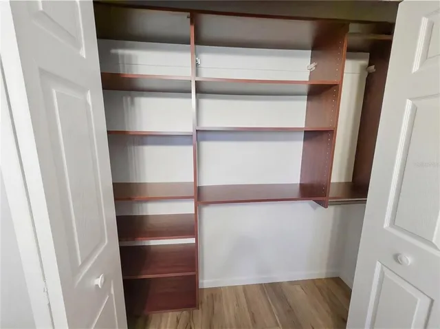 a view of a house with a big yard and large trees