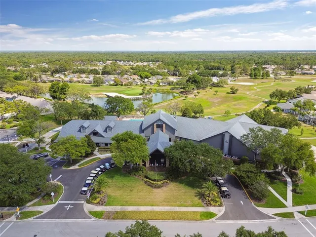 an aerial view of lake residential houses with outdoor space and swimming pool