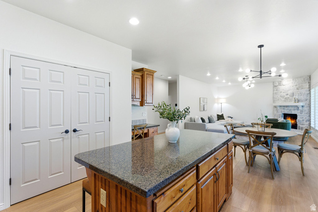 1712 Somerset Ridge Drive Draper, UT 84020 - Photo 20 of 76 Kitchen island with granite-finish countertop and wood cabinetry