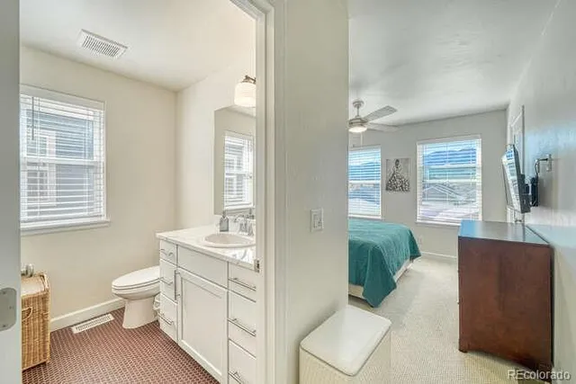 a spacious bathroom with a double vanity sink toilet and a tub