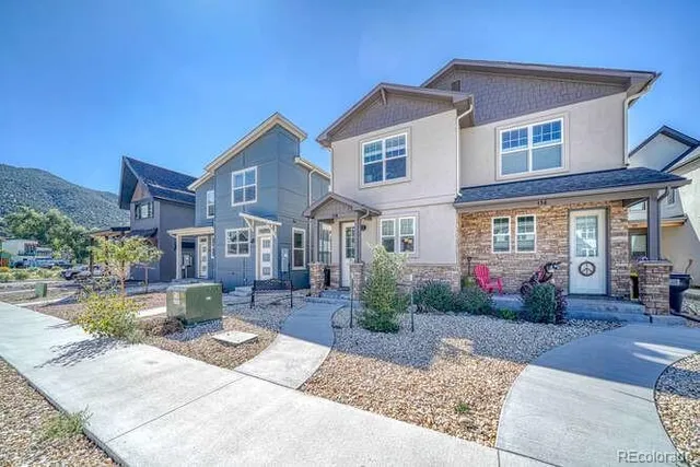 a front view of a house with garden and porch