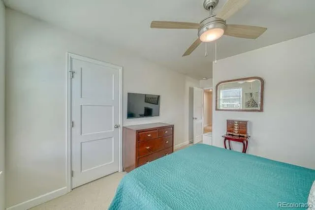 a bedroom with a bed and a television