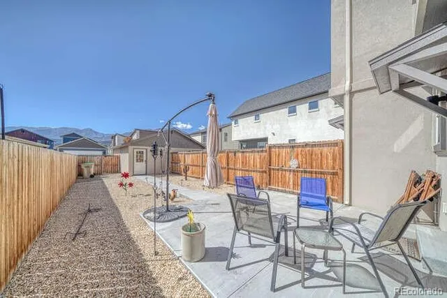 a view of a patio with a table and chairs and potted plants