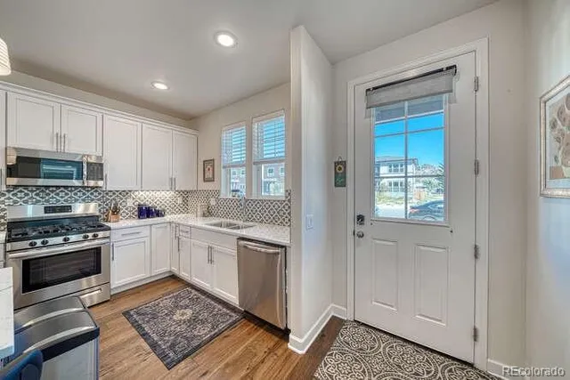 a kitchen with sink cabinets and wooden floor