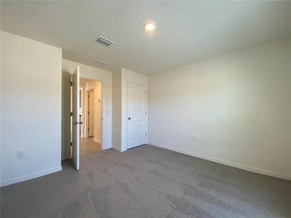 an empty room with closet area