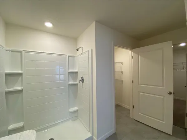 a bathroom with double sink and a mirror