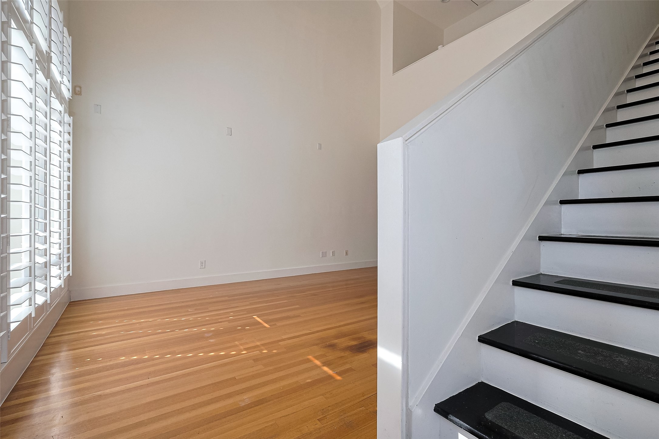 4331 Eigel Street Houston, TX 77007 - Photo 6 of 38 a view of an empty room with wooden floor and windows