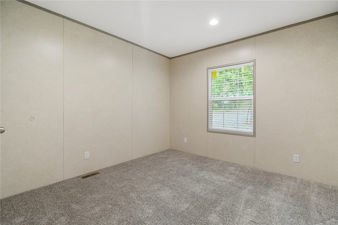 419 Austin Drive Anderson, SC 29624 - Photo 25 of 36 Bright and airy, this room features soft carpet flooring and a window offering a lush green view.