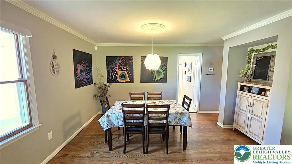 194 Springhouse Road Allentown, PA 18104 - Photo 9 of 34 This inviting dining area features crown molding, wood flooring, and a window for natural light.
