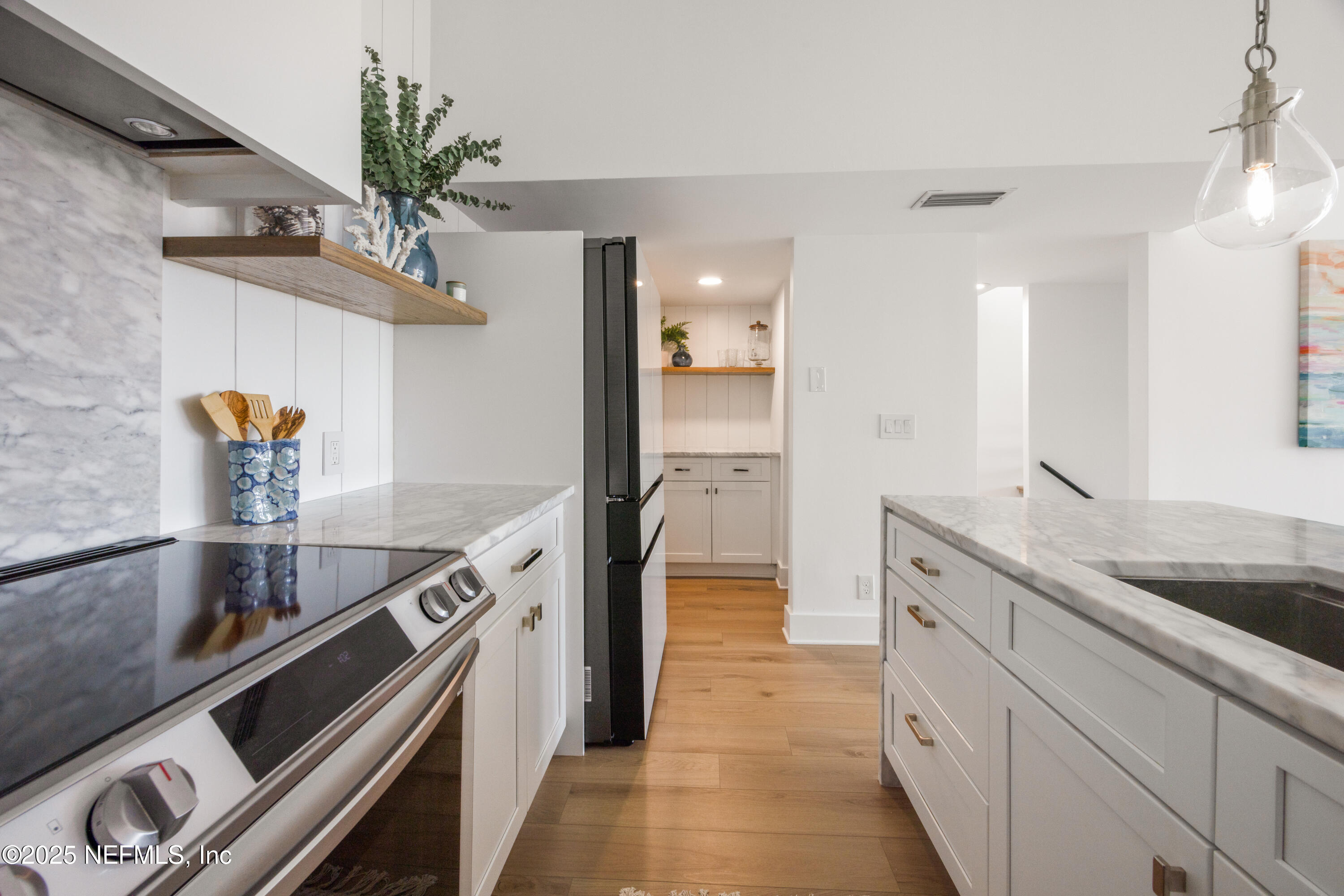 2277 Seminole Road, Unit M Atlantic Beach, FL 32233 - Photo 22 of 49 a kitchen with sink a stove and cabinets