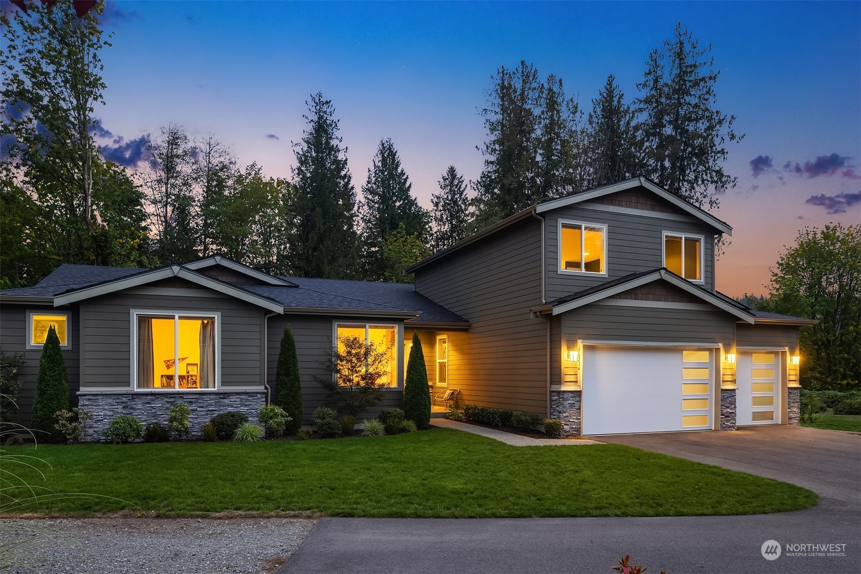 a front view of a house with a garden and yard