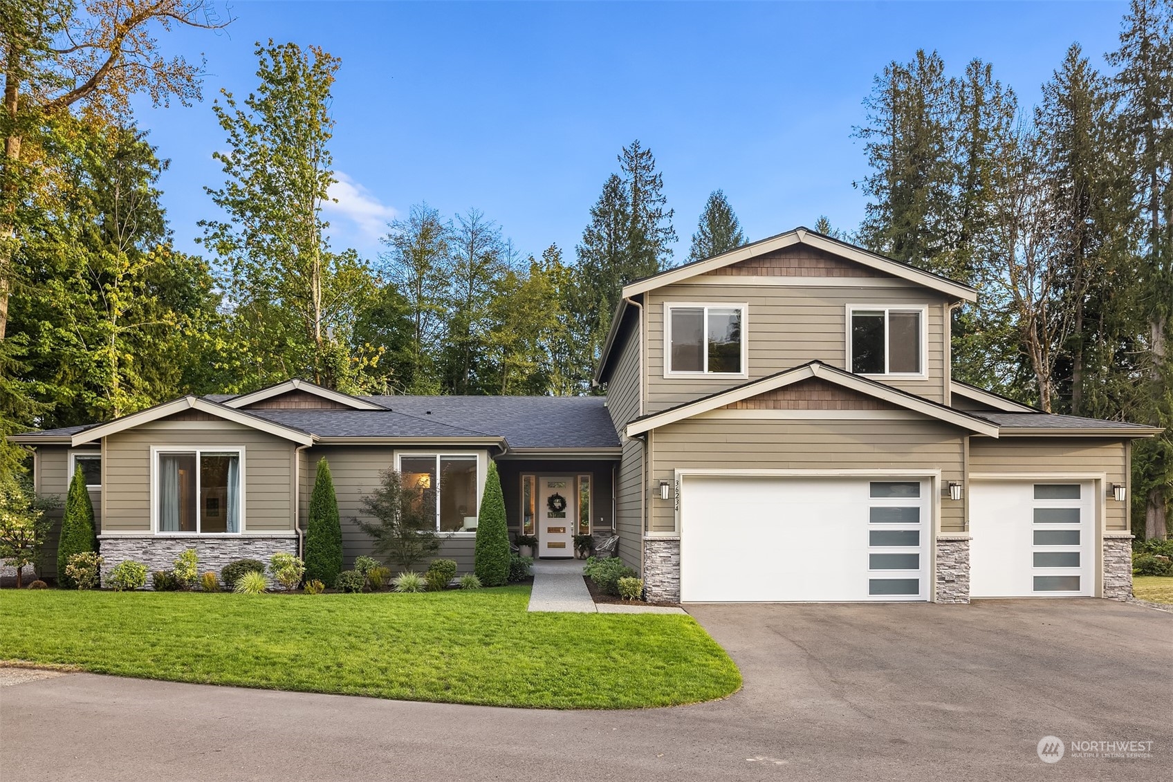 36234 Southeast Fish Hatchery Road Fall City, WA 98024 - Photo 3 of 40 a front view of a house with a garden and yard