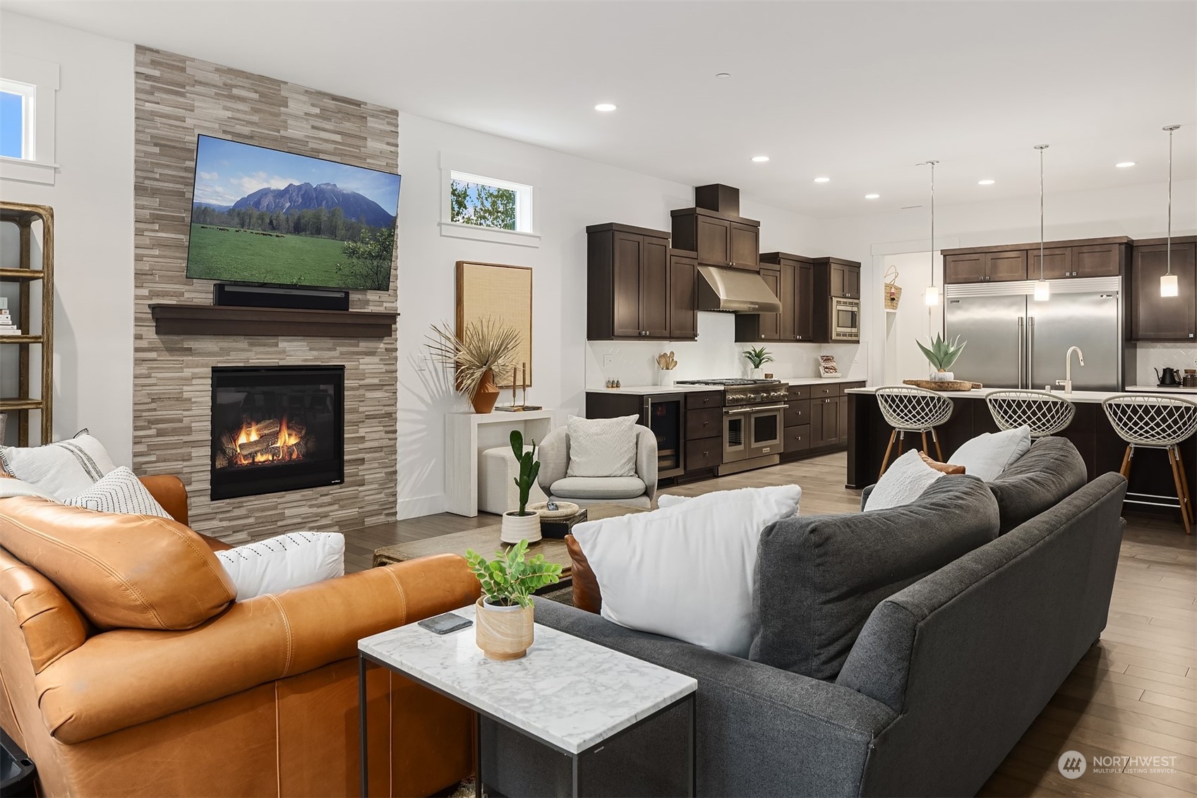 36234 Southeast Fish Hatchery Road Fall City, WA 98024 - Photo 7 of 40 a living room with furniture a flat screen tv and a fireplace