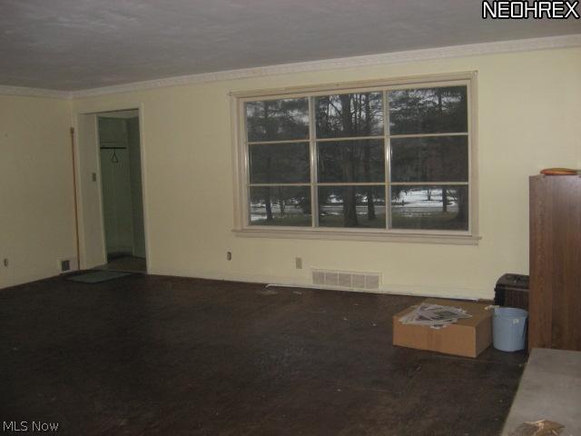 12919 County Line Road Chesterland, OH 44026 - Photo 3 of 8 Spacious living room with picture window looking out toward County Line Road. Wood burning fireplace to enjoy on a cold winter's evening.