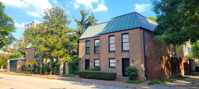 a front view of a house with a yard and tree s