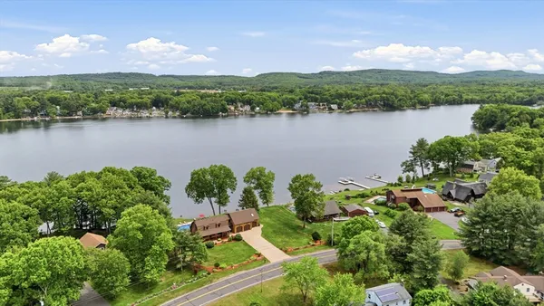 an aerial view of a houses with a lake view