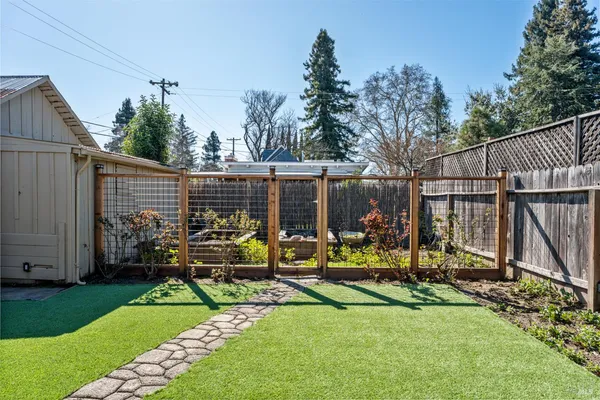 a view of a backyard with a patio and a slide