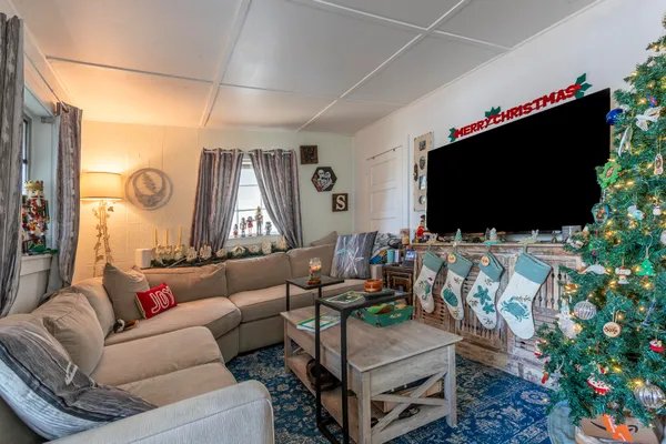 a living room with furniture and a flat screen tv