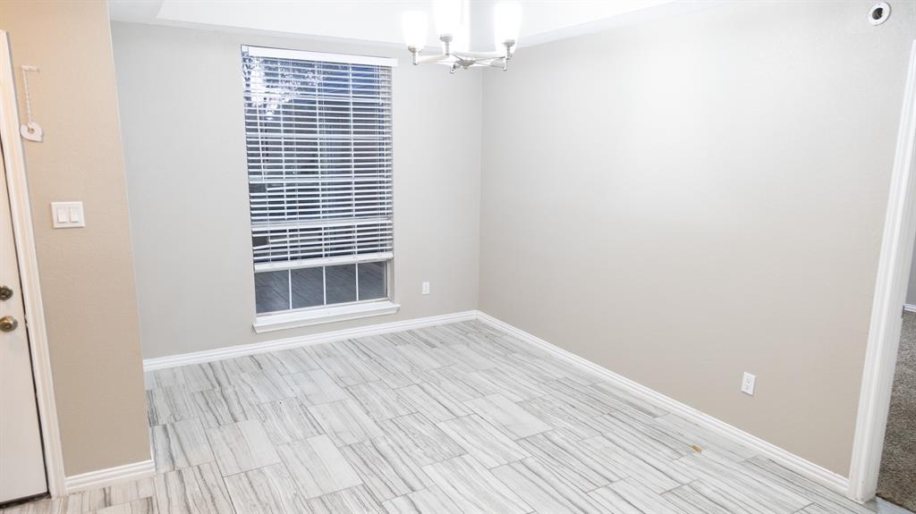 2129 Fawn Ridge Trail Carrollton, TX 75010 - Photo 12 of 30 a view of an empty room with wooden floor and a window