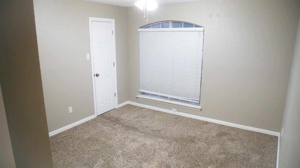 2129 Fawn Ridge Trail Carrollton, TX 75010 - Photo 13 of 30 Carpeted empty room featuring baseboards and a ceiling fan