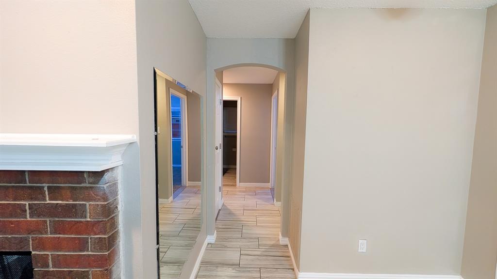 2129 Fawn Ridge Trail Carrollton, TX 75010 - Photo 16 of 30 Corridor featuring arched walkways and wood tiled floors