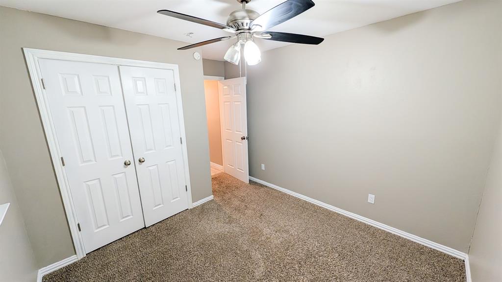 2129 Fawn Ridge Trail Carrollton, TX 75010 - Photo 20 of 30 an empty room with windows and fan