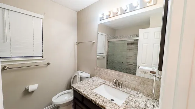 a bathroom with a double vanity sink and a mirror