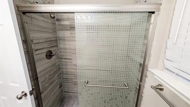 an empty room with wooden floor and ceiling fan