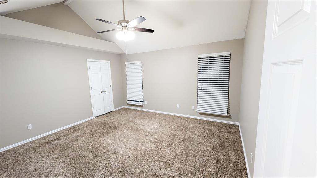 2129 Fawn Ridge Trail Carrollton, TX 75010 - Photo 25 of 30 an empty room with a ceiling fan and a window