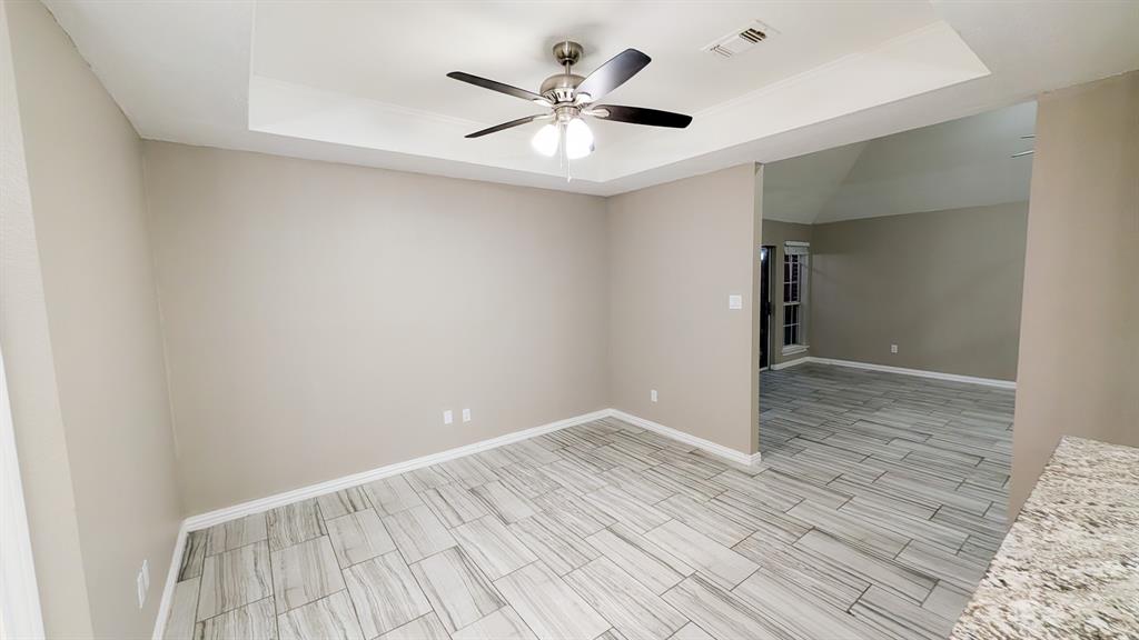 2129 Fawn Ridge Trail Carrollton, TX 75010 - Photo 28 of 30 an empty room with wooden floor and ceiling fan