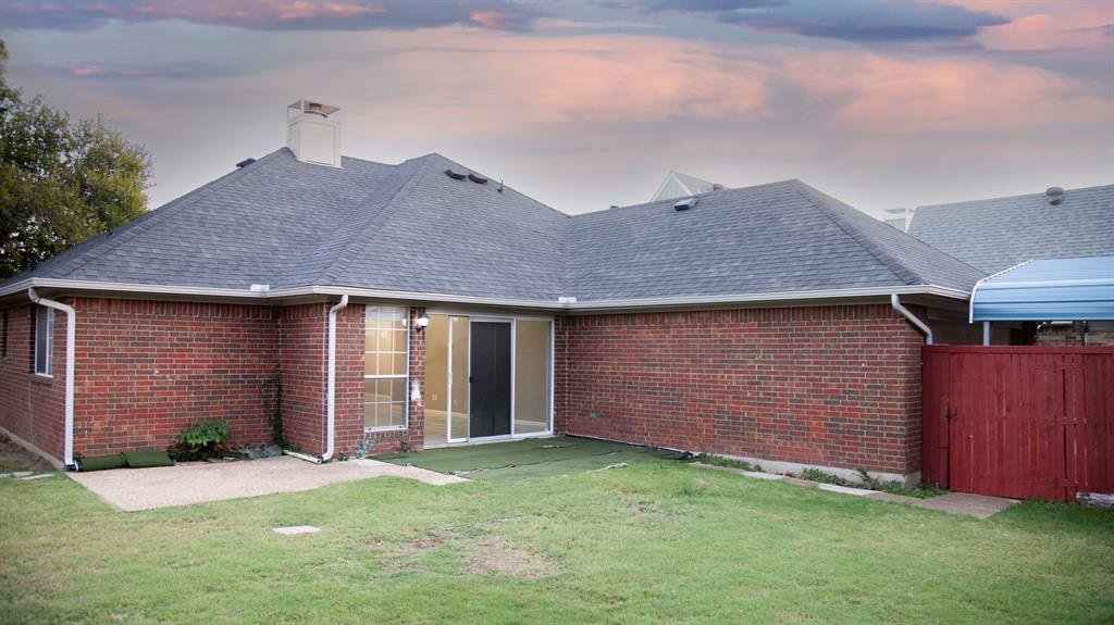 2129 Fawn Ridge Trail Carrollton, TX 75010 - Photo 30 of 30 a front view of a house with a yard and garage