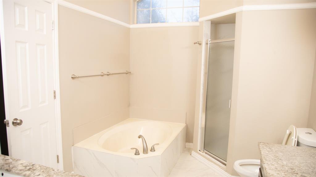 2129 Fawn Ridge Trail Carrollton, TX 75010 - Photo 4 of 30 a bathroom with a tub and shower
