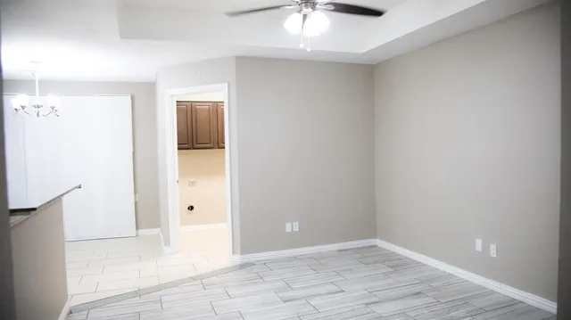 a view of an empty room with floor to ceiling window