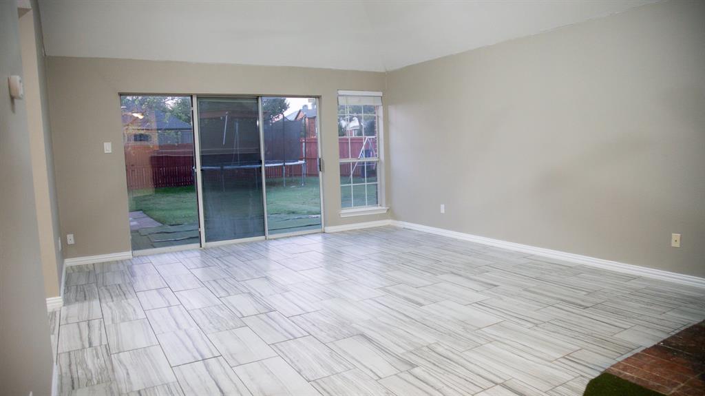 2129 Fawn Ridge Trail Carrollton, TX 75010 - Photo 9 of 30 an empty room with wooden floor and windows